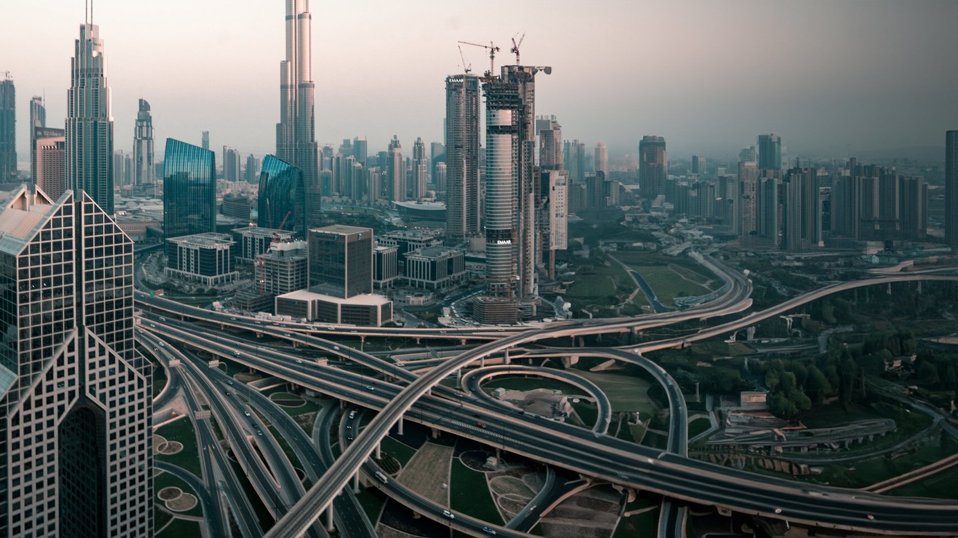 A skyline of a large modern city with a network of highways
