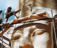 Person working on Egyptic sculpture.