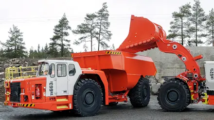 A Sandvik truck and loader in a quarry